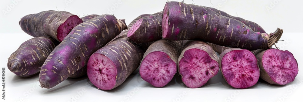 Purple sweet yams arranged on a white background, showcasing their vibrant color natural texture Purple sweet yams arranged on a white background, showcasing their vibrant color natural texture