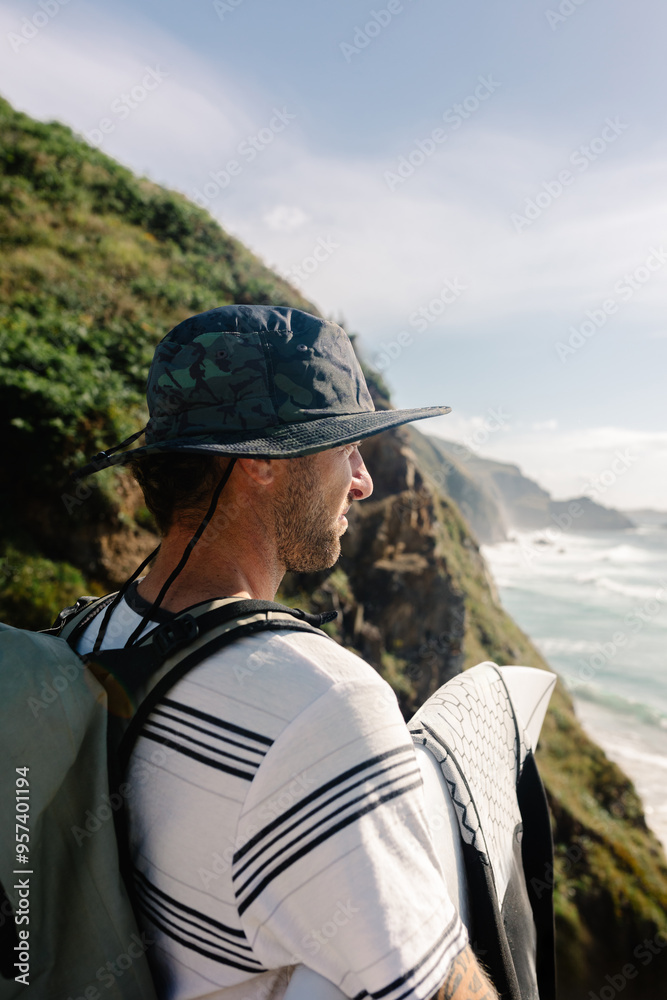Portrait of a man admiring Campello Beach while carrying his surf gear Portrait of a man admiring Campello Beach while carrying his surf gear