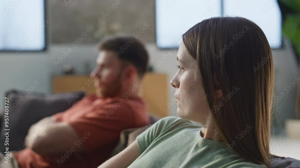 Upset wife offended husband showing dissatisfaction at home sofa closeup. Upset wife offended husband showing dissatisfaction at home sofa closeup.