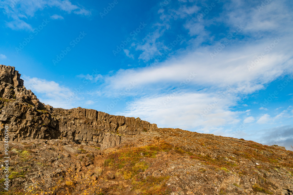 Rocky tectonic Almannagja mountain. Mountain geology rock. Geology rocky cliff. Cliff edge Almannagja. Mountain wall cliff in Iceland. Geological tectonic rock in wild nature of Iceland Rocky tectonic Almannagja mountain. Mountain geology rock. Geology rocky cliff. Cliff edge Almannagja. Mountain wall cliff in Iceland. Geological tectonic rock in wild nature of Iceland