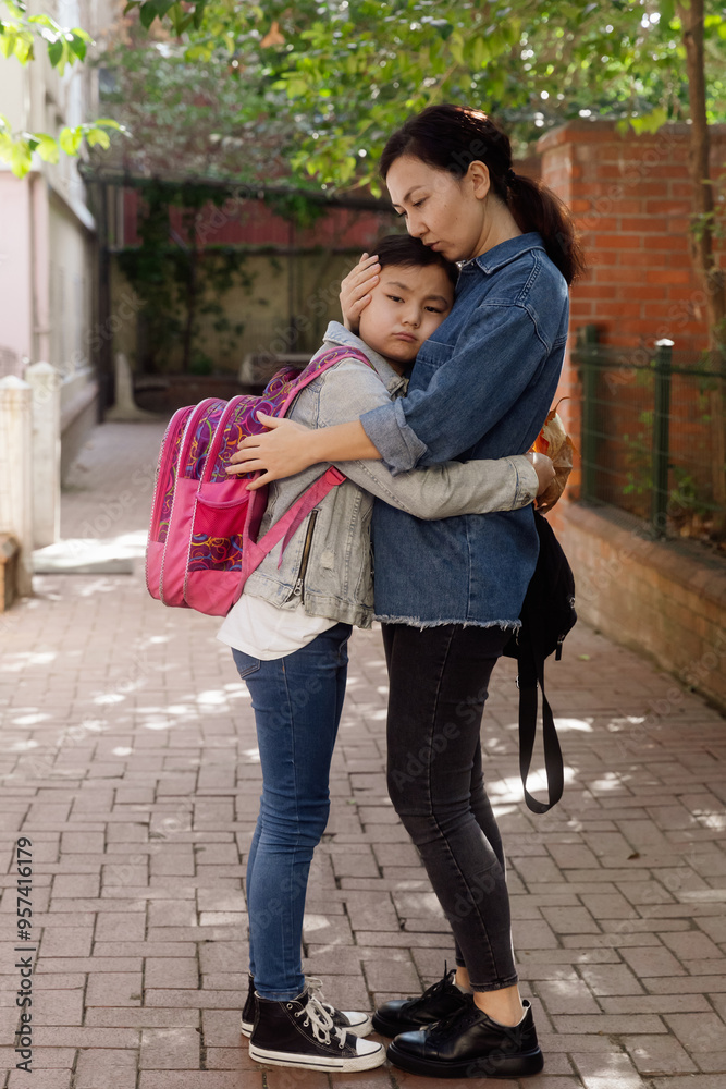 mom hugs sad daughter near school mom hugs sad daughter near school