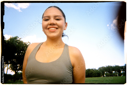Analog medium close-up portrait of a plus size woman in a park photo
