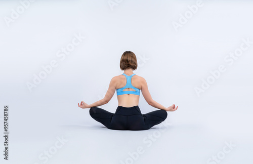 Fotografie Full body length back rear view gaiety shot athletic and sporty woman doing healthy and meditative yoga exercise workout posture on isolated background
