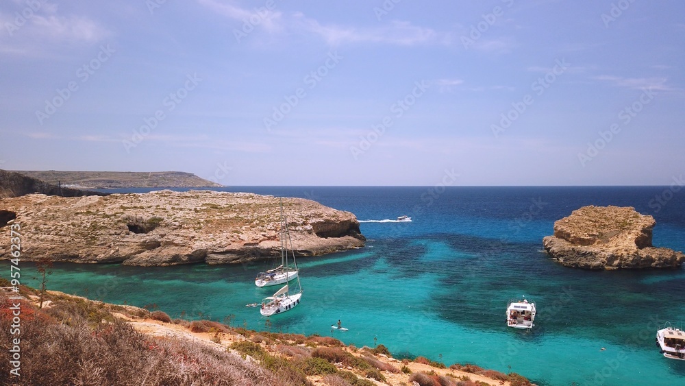 Comino, Malta 29.05.2024 - Boats anchored near Blue lagoon, Cominotto island in the back. Revealing shot. High quality photo Comino, Malta 29.05.2024 - Boats anchored near Blue lagoon, Cominotto island in the back. Revealing shot. High quality photo