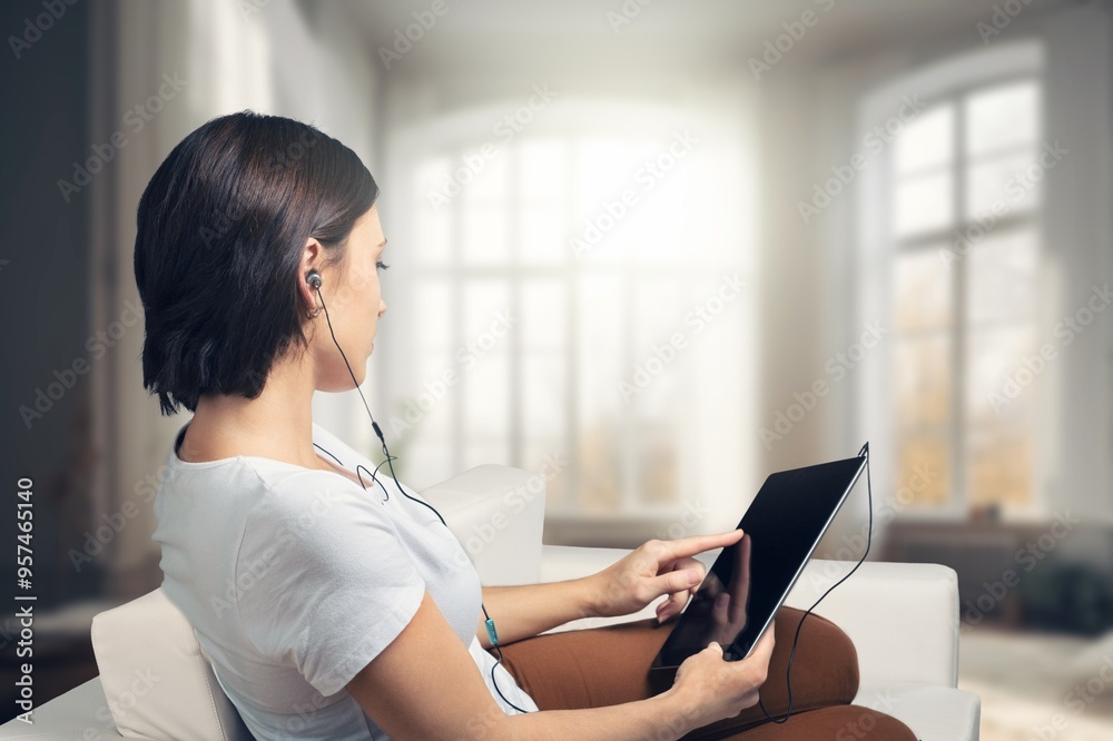 Smiling young woman use digital tablet at home. Smiling young woman use digital tablet at home.