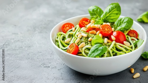 A vibrant bowl of pesto pasta with cherry tomatoes and fresh basil, perfect for healthy meal inspiration.