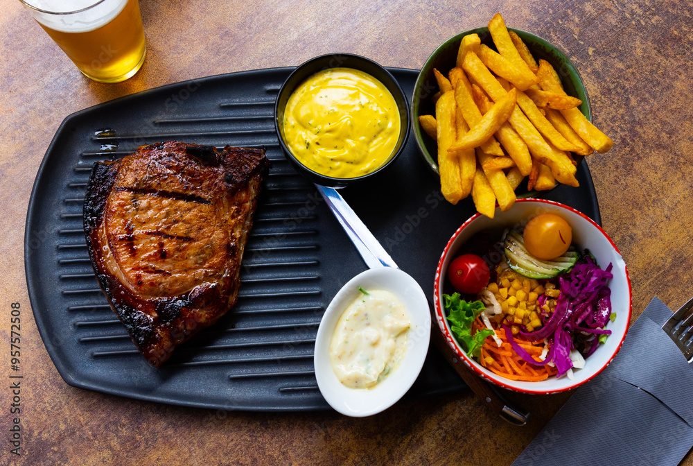 Φωτογραφία Popular dish of Belgian cuisine is an appetizing pork chop according to an old recipe in sauce in Orval, served with French