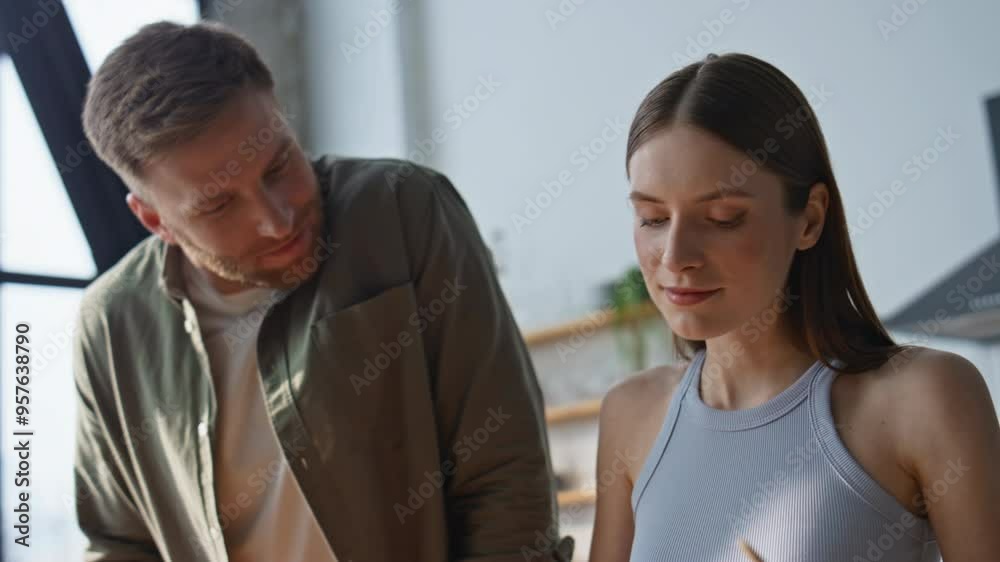 Lovely pair cooking together in modern kitchen closeup. Happy man and woman Lovely pair cooking together in modern kitchen closeup. Happy man and woman