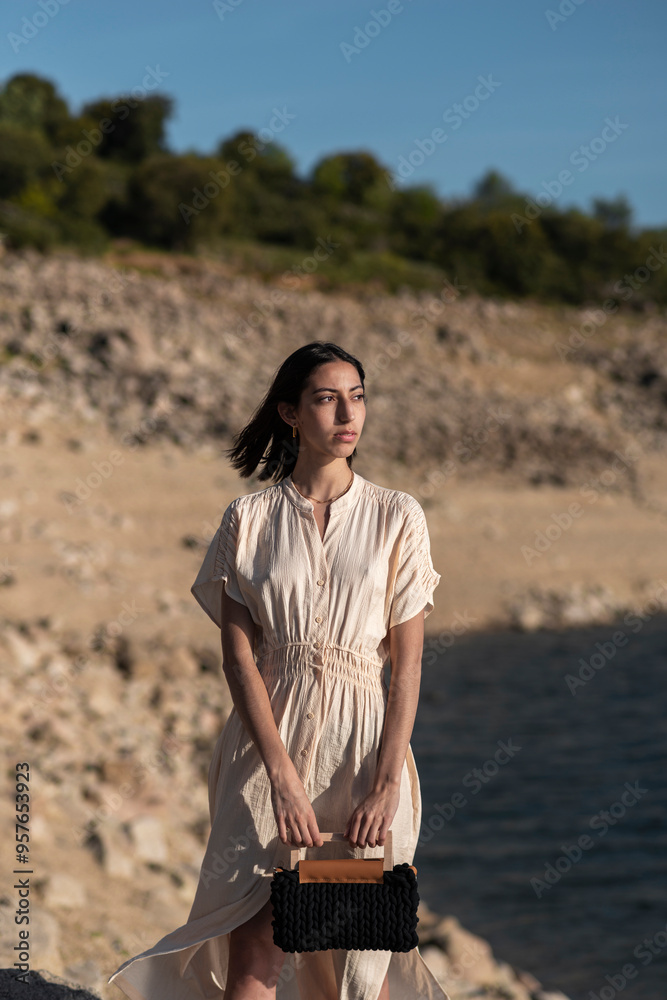 Woman standing in natural environment with casual elegance Woman standing in natural environment with casual elegance