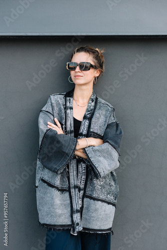 Stylish woman in sunglasses and upcycled denim jacket photo