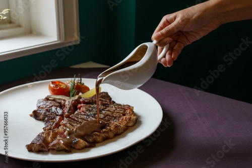Medium rare T-bone steak with gravy
