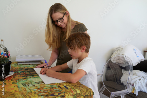 Mother helping young son with afterschool work