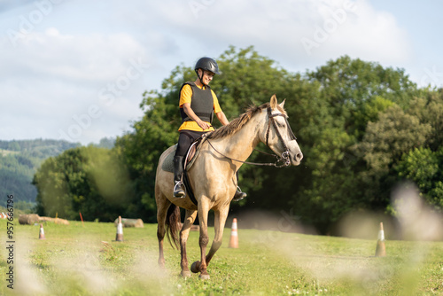 Young horse rider training for equestrian competition in open field