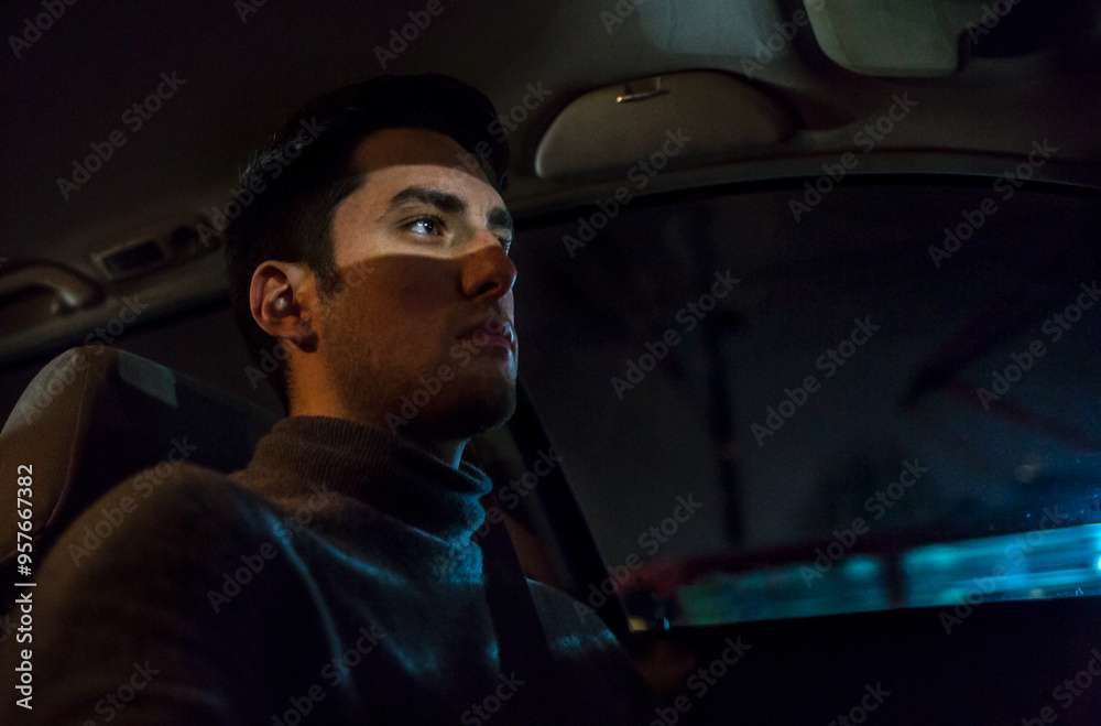 Driver lit by oncoming traffic during the night Driver lit by oncoming traffic during the night