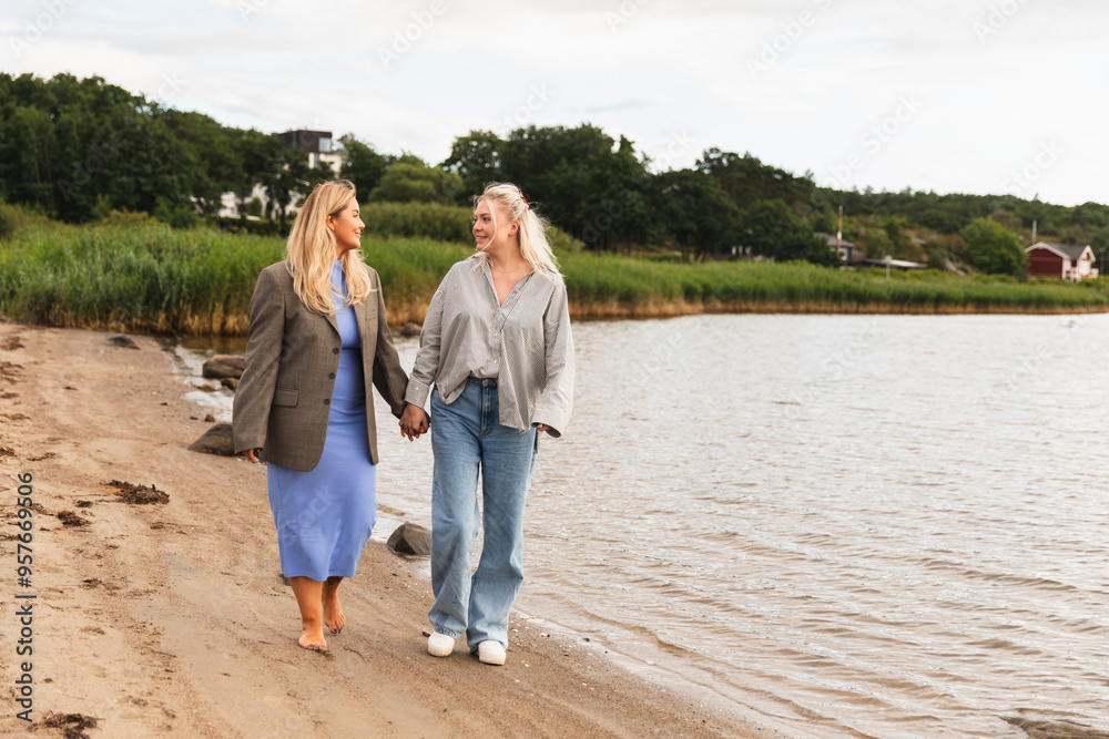 LGBT Woman Couple Walking Hand-in-Hand on Beach LGBT Woman Couple Walking Hand-in-Hand on Beach