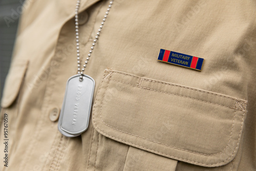 Military soldier dog tag  on uniform veteran with badge 