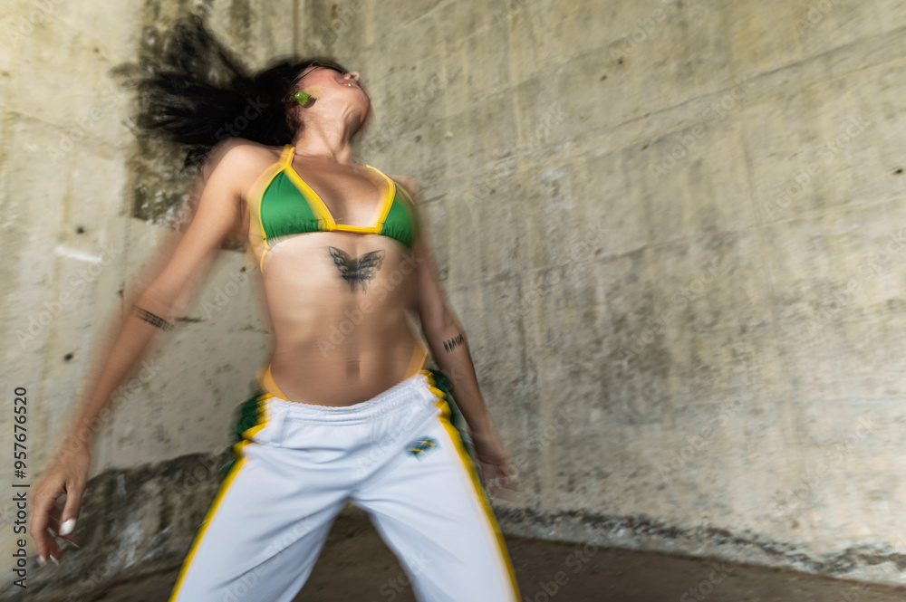 Woman dancing energetically in street style Woman dancing energetically in street style