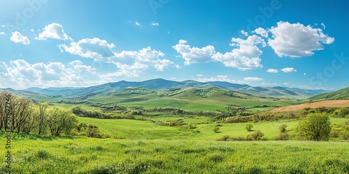 A stunning spring day landscaping views of fertile land surrounded beautiful green vegetation, wide stretches of hills and mountains with clear skies in spring 