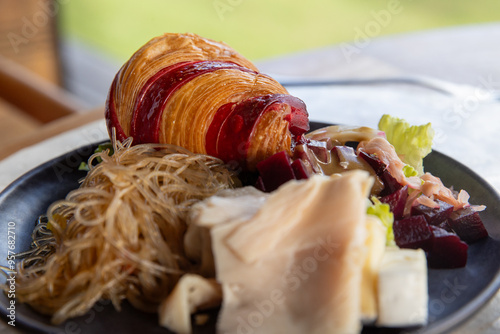 Delicious breakfast with meat and croissants in French Polynesia. The morning meal in Bora Bora is diverse and sometimes healthy food. 