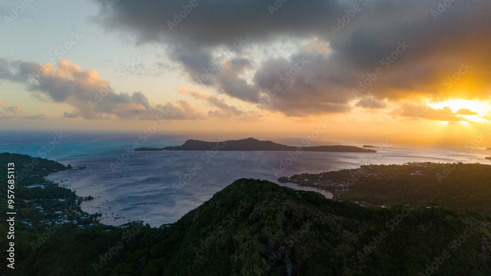 Sunset over Mount Otemanu on tropical island Bora Bora in French Polynesia. Low clouds float above the extinct volcano on the popular tourist destination in the south pacific sea. Sunset over Mount Otemanu on tropical island Bora Bora in French Polynesia. Low clouds float above the extinct volcano on the popular tourist destination in the south pacific sea.