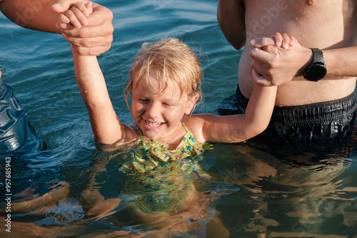 a man swimming with daughter photo