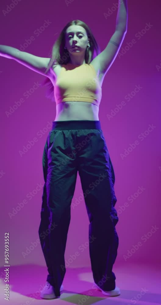Lady clubbing at disco party with colorful flashes of light on dark background. Girl dancing hip hop slow motion vertical video. Lady clubbing at disco party with colorful flashes of light on dark background. Girl dancing hip hop slow motion vertical video.