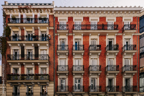 A symmetrical view of an elegant, multi-story brick building photo