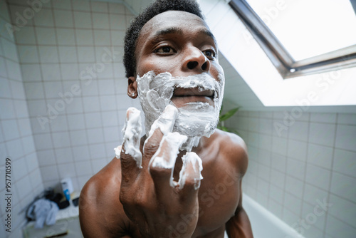 A man applies shaving foam