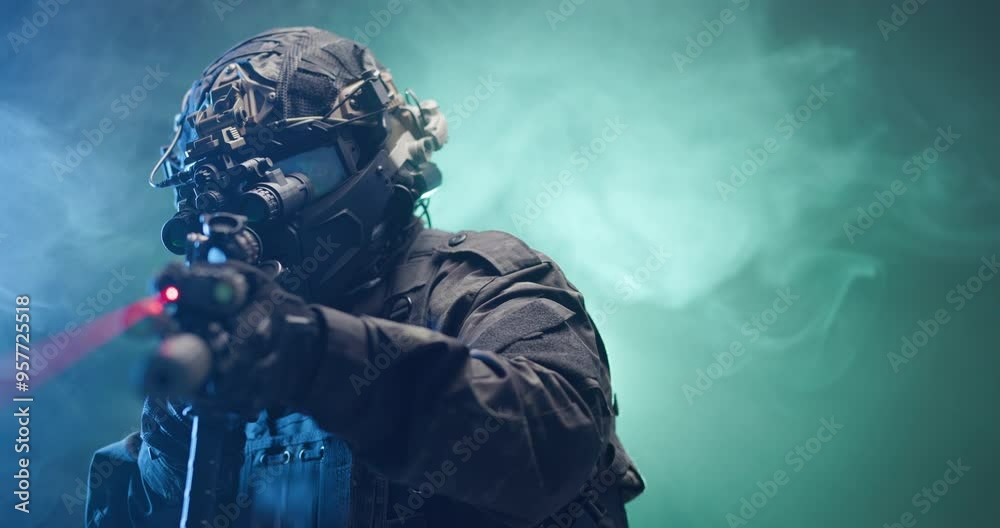 Soldier fully equipped with tactical gear and protection aiming his rifle at enemy with blue and green smoke in the background.