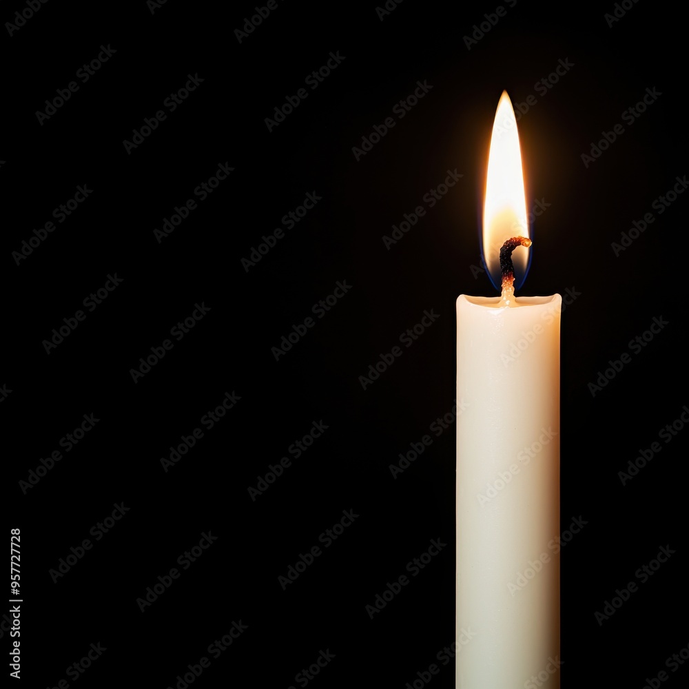 Single Burning Candle on Black Background