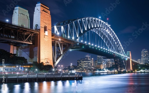 Harbour Bridge at Night: Illuminated Sydney Skyline with Reflections Background