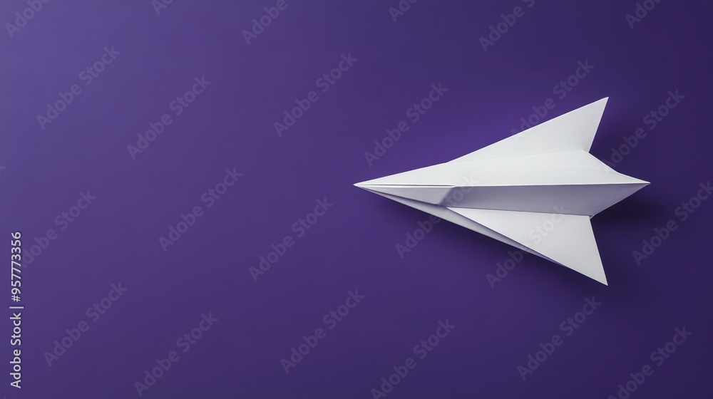 Elegant Simplicity in Modern Design - White Paper Airplane on Deep Purple Background Elegant Simplicity in Modern Design - White Paper Airplane on Deep Purple Background