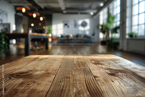 A pristine wooden table sits in foreground, while office room in background is blurred, creating a sense of spaciousness and potential for productivity in stock photo 