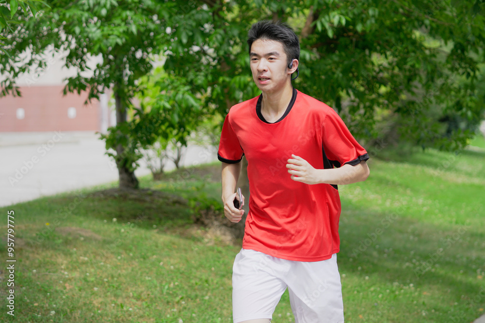 A young man is jogging with music in the city. A young man is jogging with music in the city.
