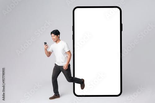A man is running out from smartphone blank screen with empty space for mobile app on screen with happy smile on face. Concept of excitement and shopping online.