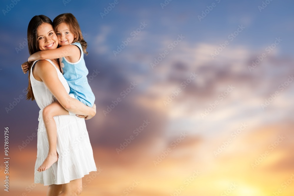 Smiling young happy mother and beautiful child at the beach