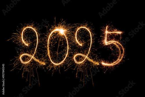 Happy New Year 2025. Burning sparkling text 2025 isolated on black background.