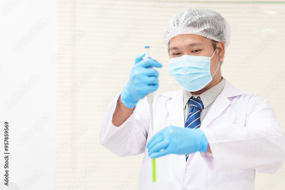 Two Asian scientists in lab coats sit at a table in a laboratory, examining samples through a microscope. The room is equipped with scientific tools, liquids, and chemistry materials. Two Asian scientists in lab coats sit at a table in a laboratory, examining samples through a microscope. The room is equipped with scientific tools, liquids, and chemistry materials.