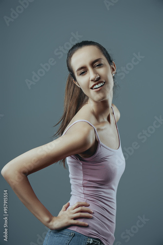 Young woman posing with hand on hip smiling