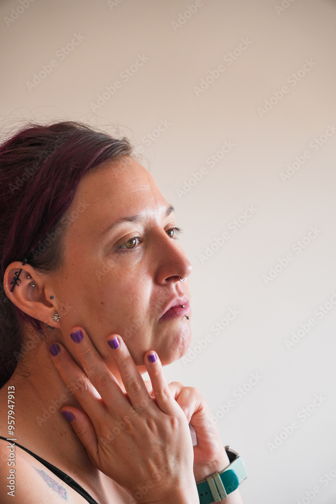 A woman with purple nails is looking at the camera A woman with purple nails is looking at the camera
