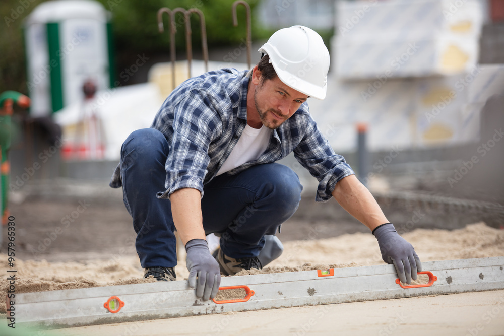 construction worker screeding on outdoor site construction worker screeding on outdoor site