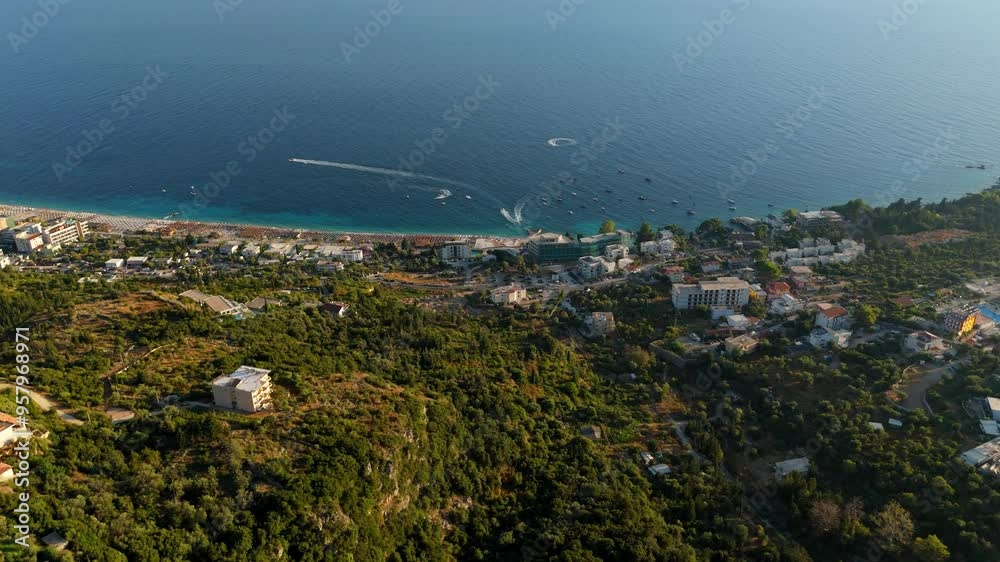 Ancient coastal town of Dhermi, Albania, viewed from above on a sunny day with blue waters Ancient coastal town of Dhermi, Albania, viewed from above on a sunny day with blue waters