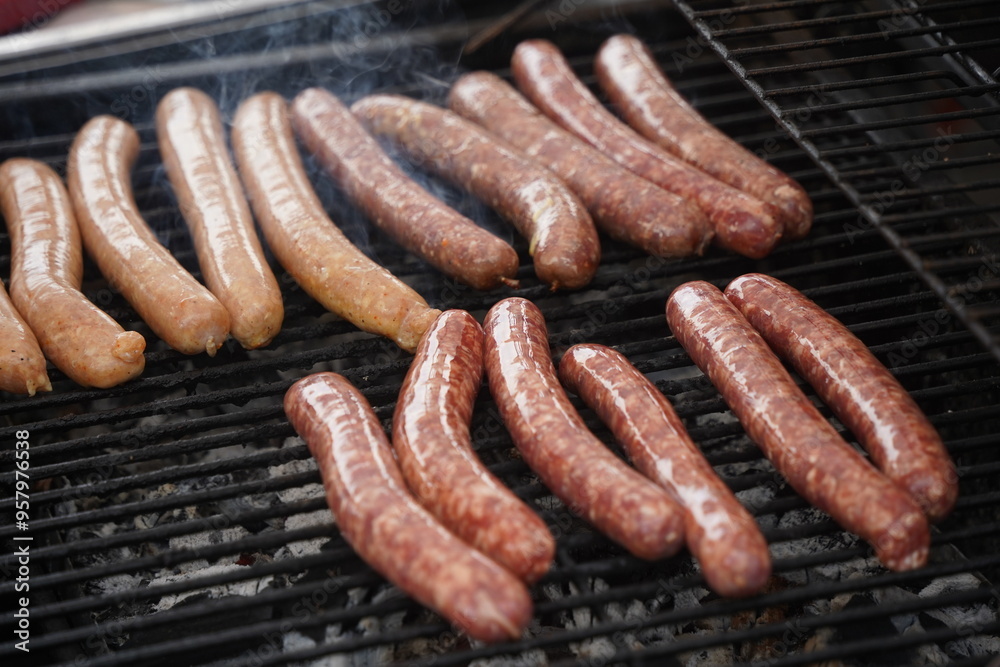 Sausages are fried on the surface of the grill. Sausages are fried on the surface of the grill.