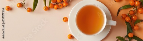 Cup of sea buckthorn tea with orange berries and green leaves on a beige background, presenting a warm autumn scene. ai