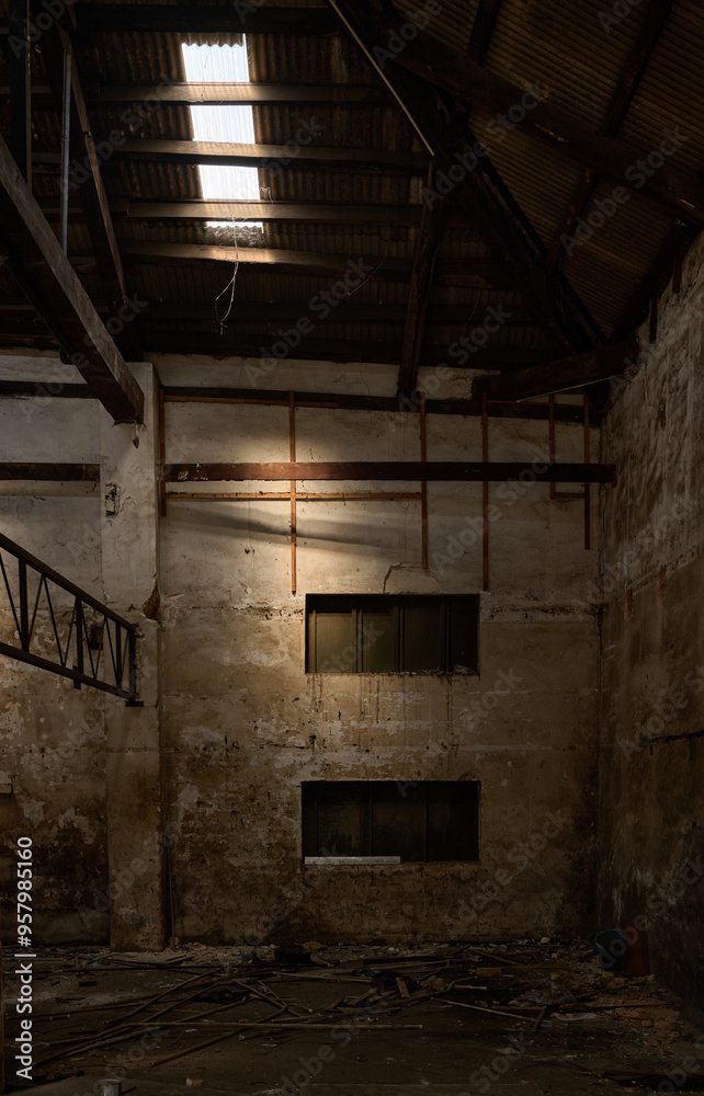 Empty warehouse with scattered debris on the floor. Empty warehouse with scattered debris on the floor.