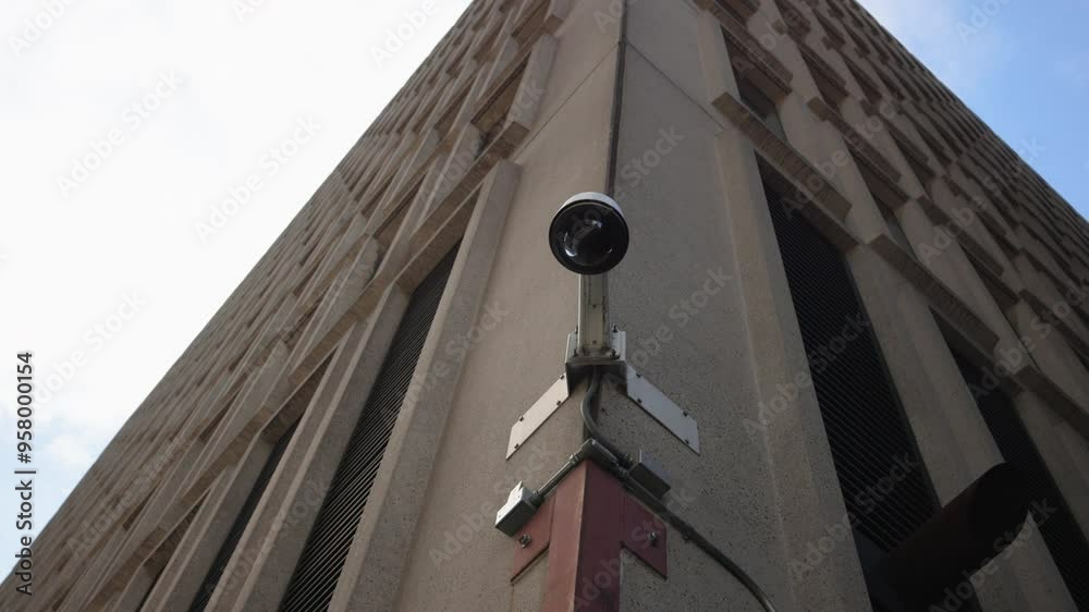 This image shows a surveillance camera on a modern building corner ...