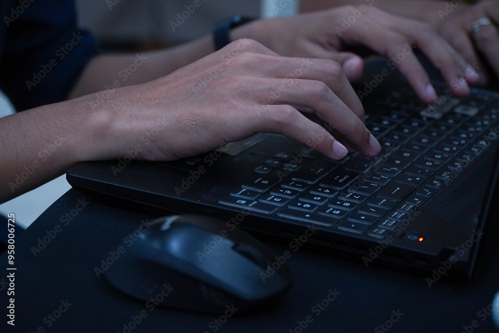Hands and fingers typing on a computer or laptop keyboard Hands and fingers typing on a computer or laptop keyboard