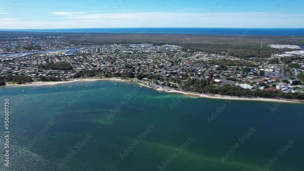 Coastal Suburb Of Bongaree In City Of Moreton Bay, Queensland, Australia. Bribie Island Bridge Revealed. aerial sideways shot Coastal Suburb Of Bongaree In City Of Moreton Bay, Queensland, Australia. Bribie Island Bridge Revealed. aerial sideways shot