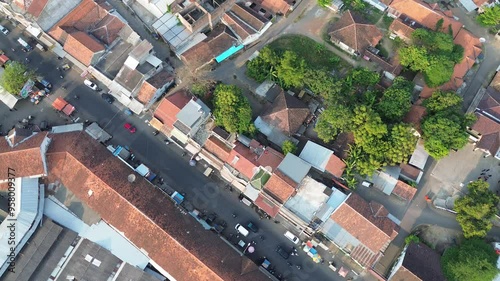 Comal Pemalang, Indonesia - September 03, 2024 : Aerial view densely packed houses, street, vehicles, trees.  photo