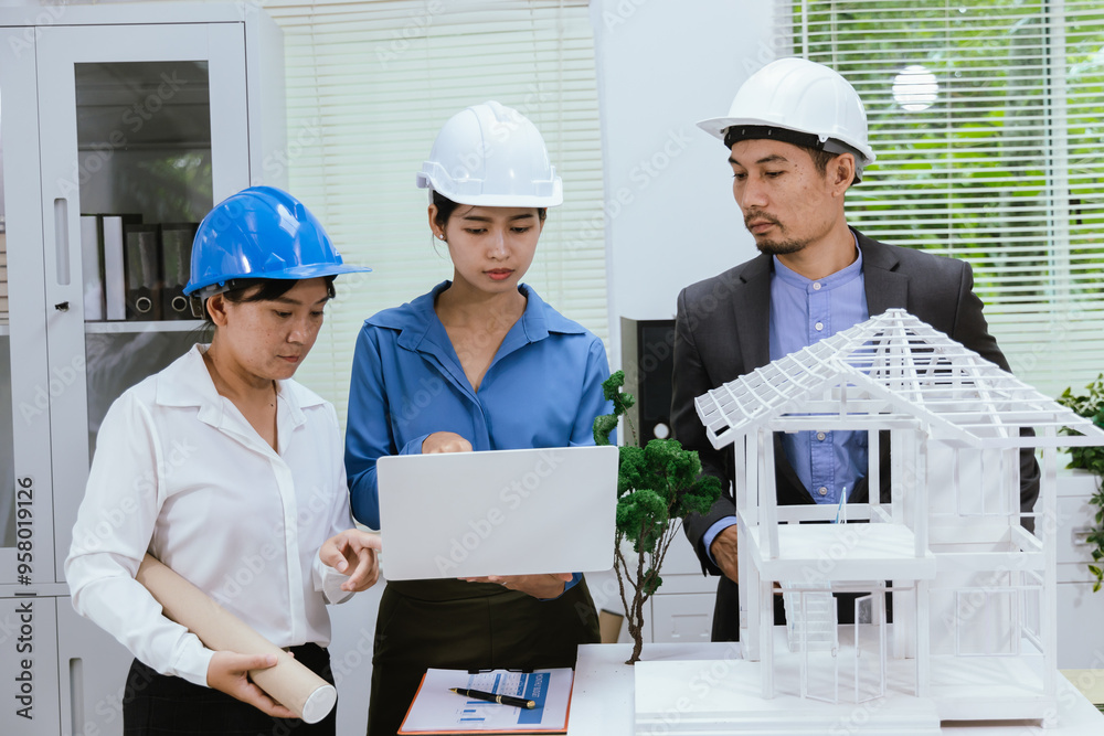 A team of architects and engineers work together in brainstorming sessions, discussing blueprints and construction plans for a real estate development. A team of architects and engineers work together in brainstorming sessions, discussing blueprints and construction plans for a real estate development.